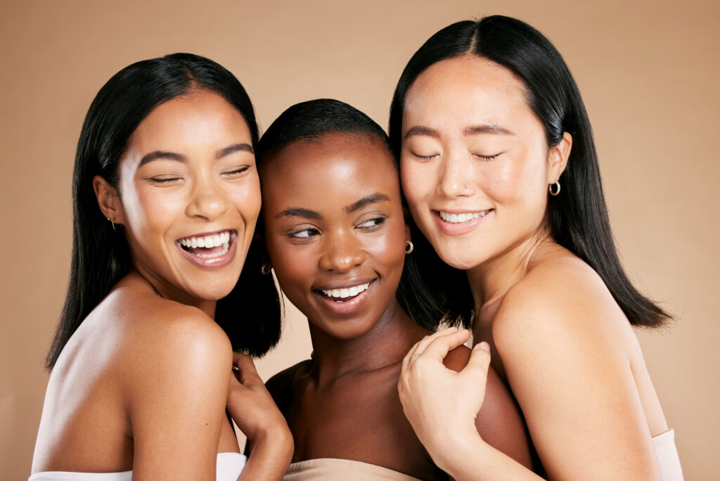 Skincare, beauty and diversity, happy women with smile and eyes closed on studio background. Health, wellness and luxury cosmetics, healthy skin care and beautiful, friendly people in natural makeup